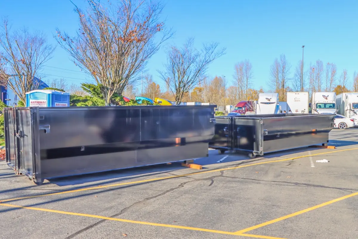 Professional dumpster rental service with roll-off container on residential driveway in Chickasaw